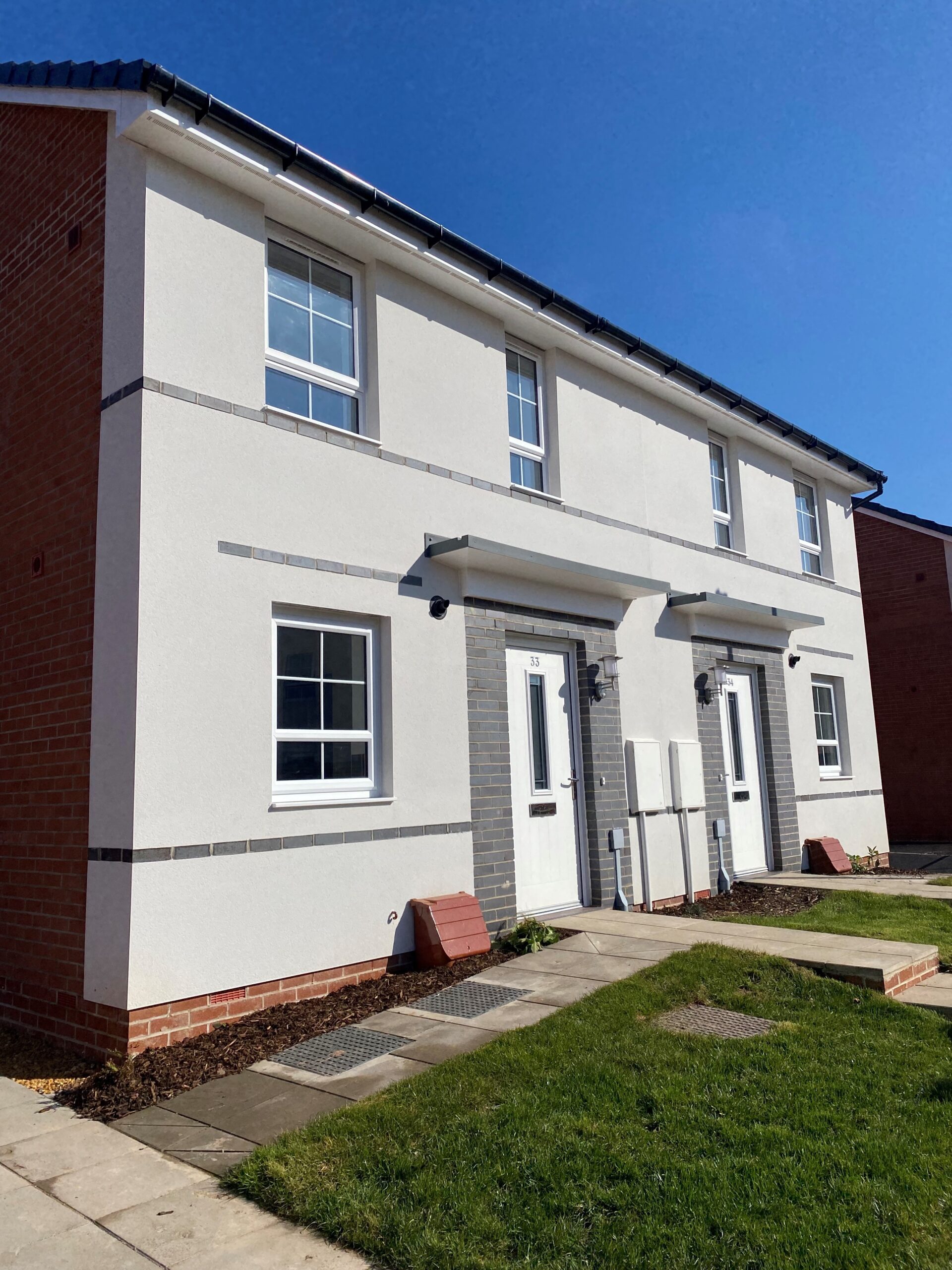 Semi-detached homes with white render