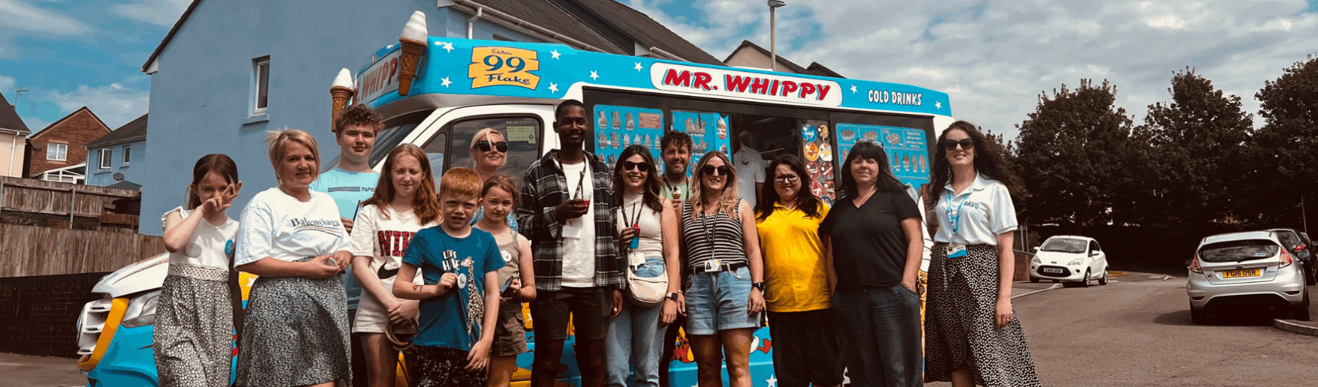 Hafod Housing Association customers and colleagues at an event standing infront of an ice cream van