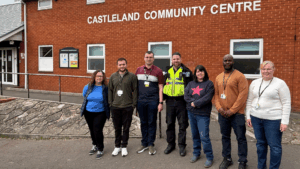 Hafod Housing Association neighbourhood coaches with a PSCO infront of a community centre